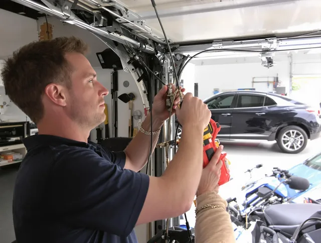 North Port Garage Door Repair safety certified technician performing cable replacement in North Port